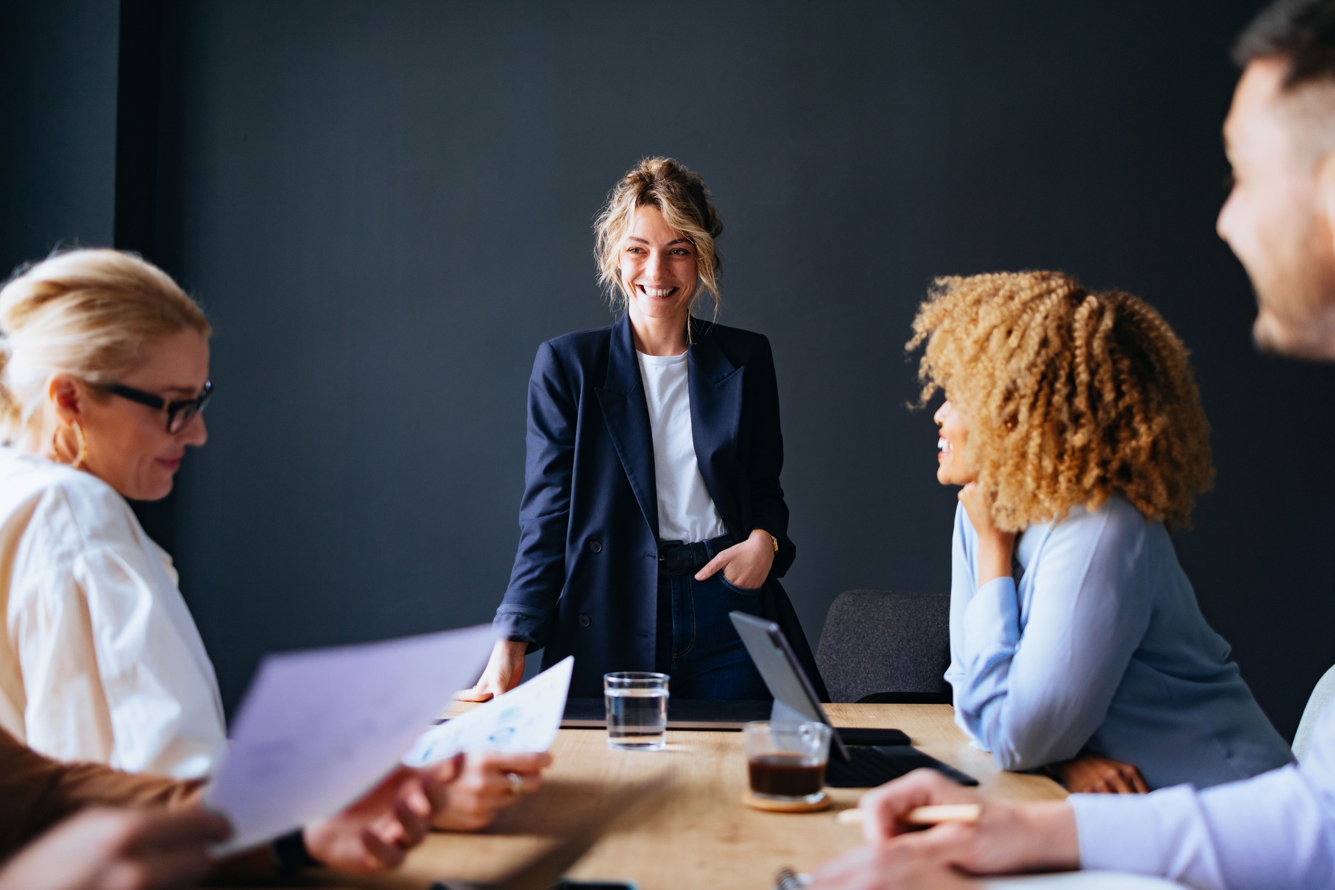 Group Of Smiling Businesspeople On A Meeting At Their Company
